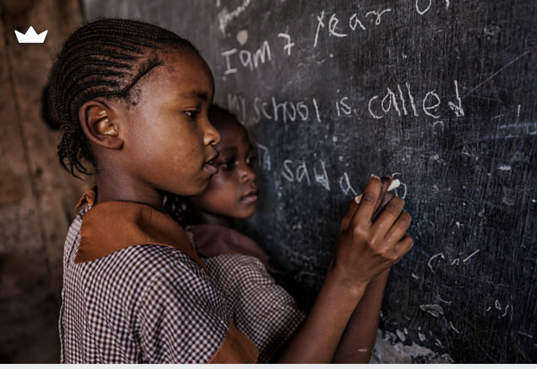 A teacher reviewing a pupil's exercise book
